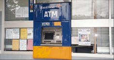 Picture of Ray Pasnen poster by the ATM on Main Street in Pemberton, Western Australia.