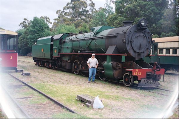 Ray Pasnen is front of the Steam Engine Locomotive in Pemberton's Rail Yard.