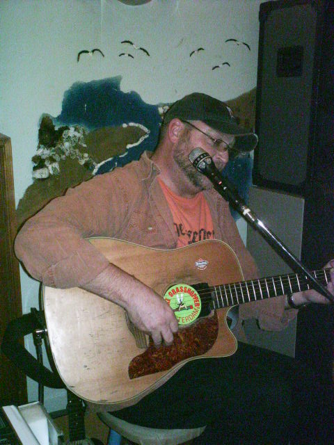 Ray playing guitar at Maria's